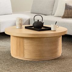 a coffee table with a tea pot on top