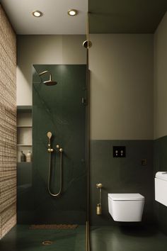 a bathroom with green tile and gold fixtures