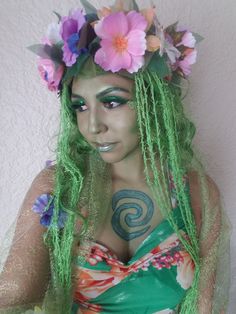 a woman with green hair and flowers on her head