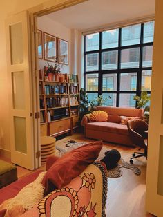 a living room filled with furniture and a large window