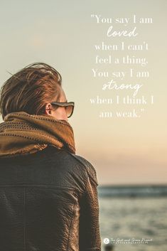 a woman wearing sunglasses looking out at the ocean with an inspirational quote above her that reads, you say i am loved when i can't feel a thing you