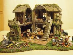 an elaborately decorated doll house with many figurines on the outside and inside