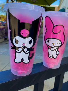 two plastic cups with pink and black designs on them