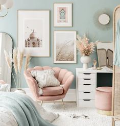 a bedroom with blue walls and pictures on the wall above it, including a pink chair