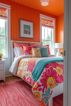 a bedroom decorated in bright colors with orange walls and pink rugs on the floor