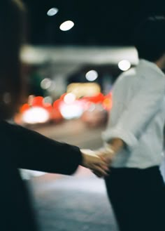 two people shaking hands in the dark