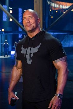 the rock posing for a photo in his gym gear