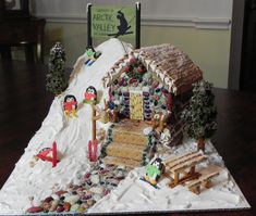 a gingerbread house made to look like it is on top of a snow covered hill