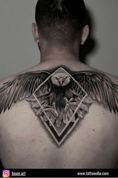 an eagle tattoo on the back of a man