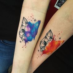 two people with matching tattoos on their arms, one has an origami and the other has a fox