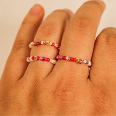 a woman's hand wearing a ring with beads on it