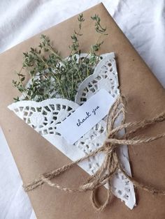 an envelope with a thank note attached to it and some twine on the side