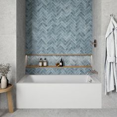 a white bath tub sitting next to a wooden shelf