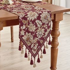 the table runner is adorned with tassels and beads