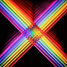 an abstract image with multicolored lines in the shape of a x on a black background