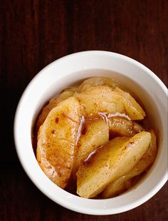 a bowl filled with baked apples on top of a wooden table and text overlay reads quick & easy baked apple weight watchers