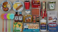 an assortment of food items are displayed on a refrigerator door sill, including hotdogs, ketchup, mustard, and other condiments