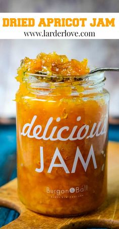 a jar filled with jam sitting on top of a wooden cutting board