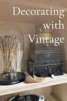 an old suitcase is sitting on a shelf next to other antique items, and the words decorating with vintage written in white