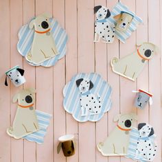 paper plates with dogs on them are hanging on the wall