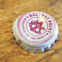 a bottle cap sitting on top of a wooden table