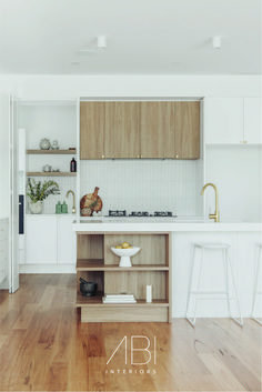 a kitchen with wooden floors and white walls