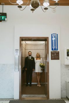 a man and woman standing in an elevator