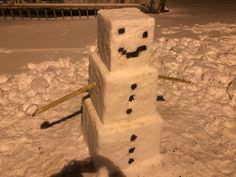 there is a snowman made out of bricks in the snow