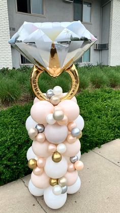 a large balloon sculpture made to look like a ring with pearls and diamonds on it