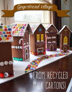 gingerbread houses made from milk and candy are displayed on a table with the caption love these gingerbread houses made from milk and candy