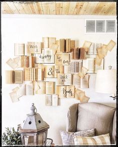 a living room with lots of books on the wall and a lamp next to it