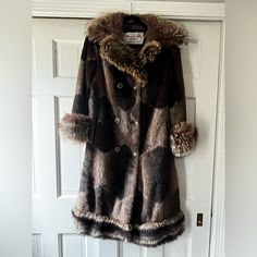 1960’s Vintage Lou Nierenberg Faux Fur Coat. It Is “Muskat” Style And Is In Great Condition For Its Age. Inside Lining Has A Few Imperfections. I Believe The Collar And Trim Are Real Fur. Tag Notes It Is A Size 10. Has All Original Buttons. Own A Piece Of West Hartford History! Original Tag Has This Being Sold At Town And Country In West Hartford. Open To Offers! It Really Is A Standout Piece Of History! Fitted Wool Fur Coat For Fall, Retro Fitted Fur Coat With Faux Fur Trim, Retro Fitted Long Coat, Fitted Retro Long Coat, Vintage Fitted Outerwear With Faux Fur Lining, Vintage Fitted Fur Coat For Winter, Retro Fitted Winter Outerwear, Fitted Retro Fur Coat For Fall, 1970s Fitted Winter Outerwear