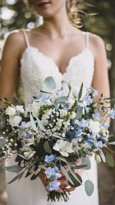 a woman holding a bouquet of flowers in her hands