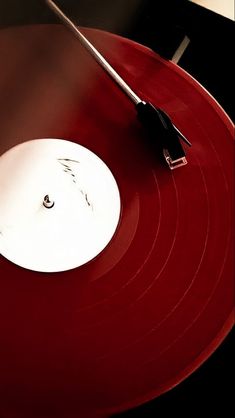 a red record with a black and white object on it