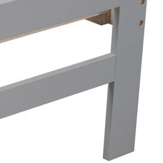 a close up of a gray wooden bed frame