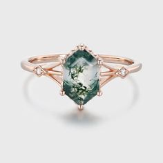 a green and white ring with diamonds on the sides, set in 18k rose gold