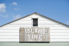 a sign on the side of a white building