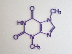 an image of the structure of a chemical model on a white wall with blue paint