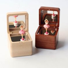 a wooden box with two figurines in it