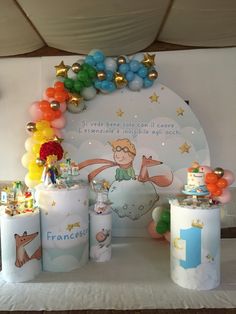 a table topped with lots of balloons and decorations