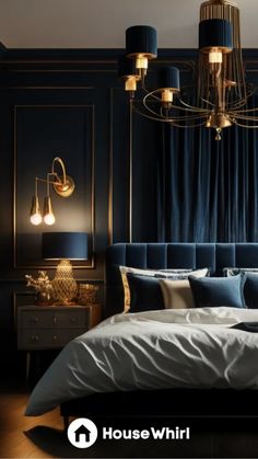 a bedroom with blue walls, gold accents and a bed in the foreground is a chandelier