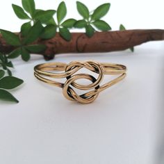 "This simple and stunning Love Knot bracelet was handmade in Mexico. Handcrafted to the highest quality from 3 mm solid brass wire. Declare your eternal love and friendship in style! The love knot symbolises the unbreakable bond and eternal connection between lovers. The bracelet is 7\" inches in circumference and is adjustable (by squeezing gently) down to 6\" and up to 8\" If you've got any questions don't hesitate to ask me. This bracelet comes gift wrapped in an organza bag. I dispatch order Adjustable Bohemian Bangle For Anniversary, Adjustable Infinity Friendship Jewelry, Gift Bangle Jewelry With Sliding Knot, Adjustable Brass Bracelet As Gift, Adjustable Brass Bracelets As Gift, Adjustable Brass Bracelet For Gift, Adjustable Brass Bracelet Gift, Adjustable Brass Bracelets For Anniversary, Handmade Adjustable Bracelets For Anniversary