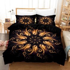 a bed with black and gold comforters in a room