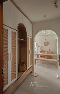 an archway leads to the dining room and living room in this modern style house with white walls