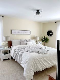 a bedroom with a bed, nightstands and lamp in it's centerpiece