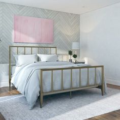 a bedroom with a bed, nightstand and painting on the wall