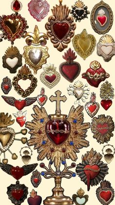 an assortment of heart and cross brooches on display in a white background,