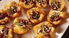 small appetizers with nuts and dried herbs on a white plate, ready to be eaten