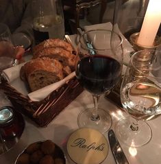 a table topped with bread and glasses of wine