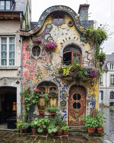 a colorful house with lots of flowers on the outside